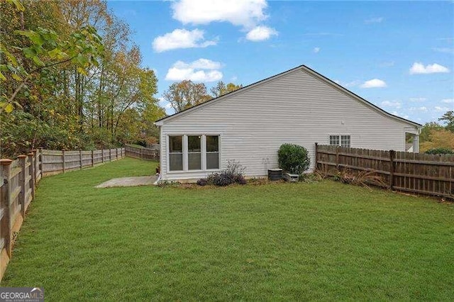 rear view of house with a yard