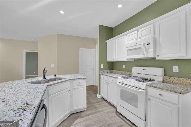 kitchen featuring sink, light stone countertops, white appliances, white cabinets, and light wood-type flooring