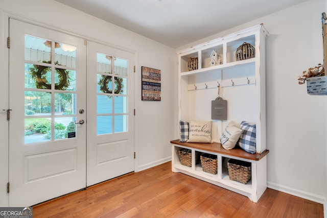 mudroom with light wood-type flooring and french doors