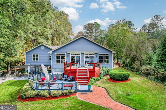 back of house featuring a yard and a wooden deck