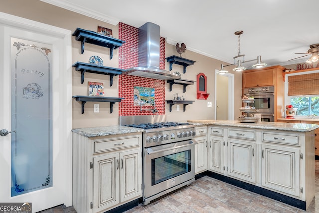 kitchen with ceiling fan, wall chimney range hood, appliances with stainless steel finishes, and ornamental molding