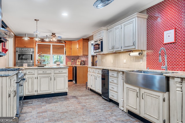 kitchen featuring stainless steel appliances, decorative light fixtures, decorative backsplash, sink, and ceiling fan