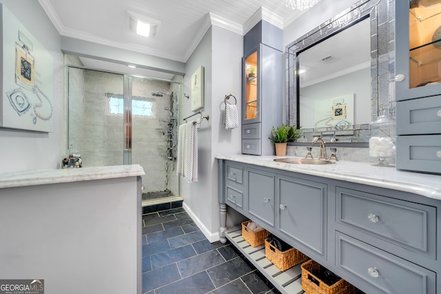 bathroom with a shower with shower door, vanity, and ornamental molding