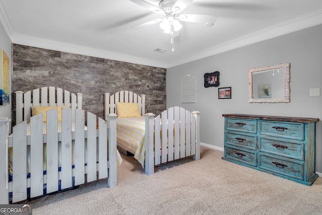 carpeted bedroom with ornamental molding and ceiling fan