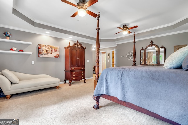 bedroom featuring ceiling fan, ornamental molding, and a tray ceiling