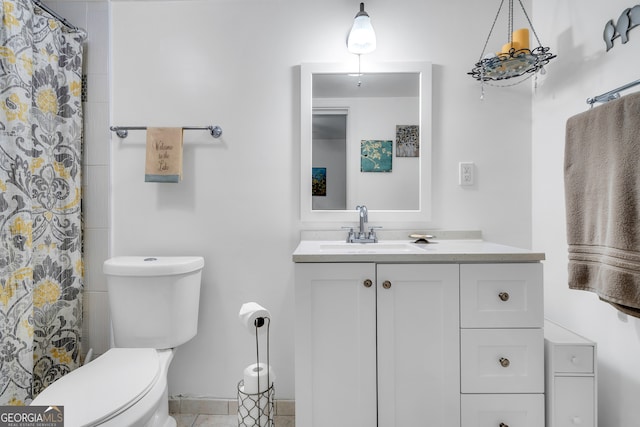 bathroom featuring tile patterned floors, vanity, and toilet