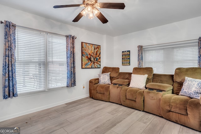 living room with ceiling fan and light hardwood / wood-style flooring