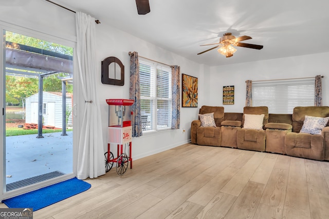 living room featuring light hardwood / wood-style floors and ceiling fan