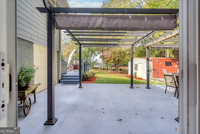 view of patio / terrace with a pergola and a shed