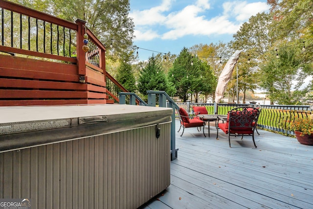 wooden terrace featuring a hot tub