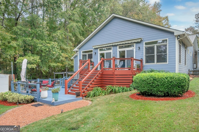 view of front of house featuring a front yard and a deck