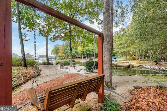 exterior space with a water view and a dock