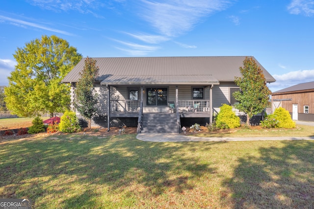 view of front of house with a front yard and covered porch