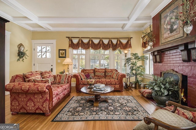 living area with a fireplace, beam ceiling, coffered ceiling, and hardwood / wood-style floors