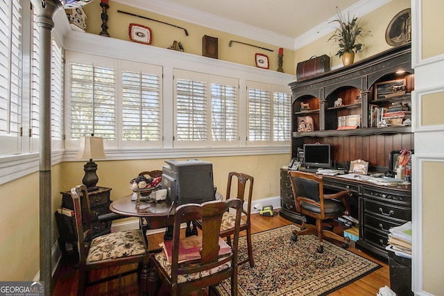 office with ornamental molding, wood finished floors, and baseboards