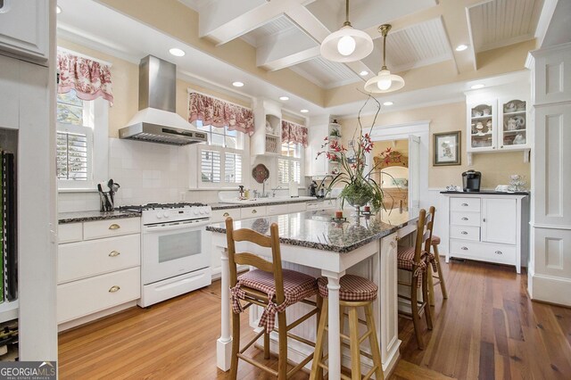 kitchen with coffered ceiling, extractor fan, white cabinets, and white appliances