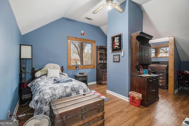 bedroom with lofted ceiling, ceiling fan, light wood-style flooring, visible vents, and baseboards