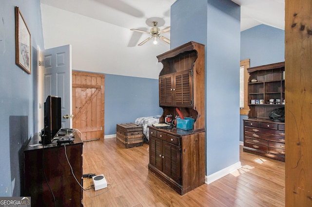 interior space with lofted ceiling, light wood-type flooring, and baseboards