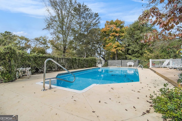 view of pool with a patio area, fence, and a fenced in pool