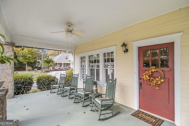 view of patio with ceiling fan and a porch