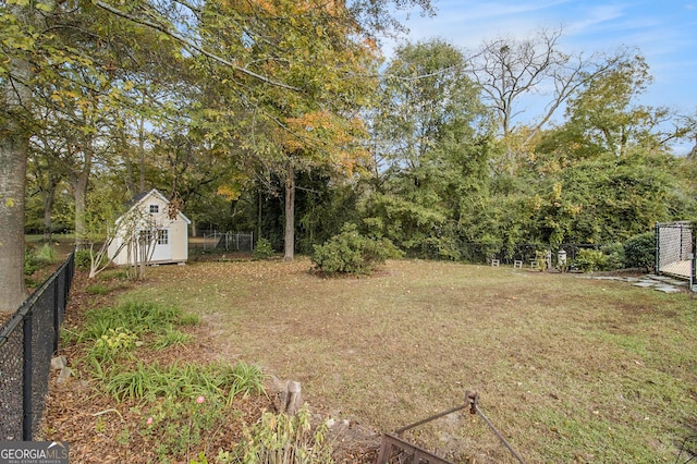 view of yard featuring a fenced backyard, an outdoor structure, and a shed