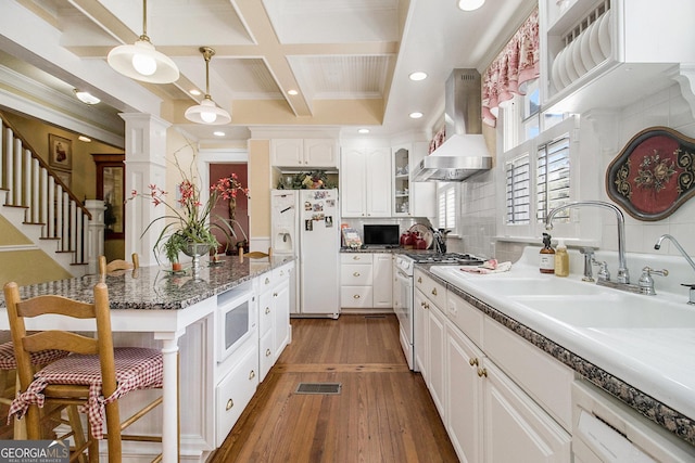 kitchen featuring white appliances, glass insert cabinets, white cabinets, and range hood