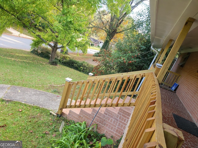 wooden deck featuring a yard