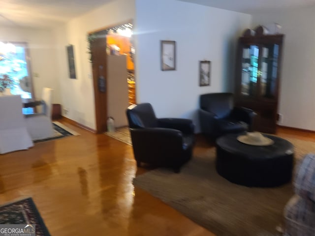 living room with hardwood / wood-style flooring and an inviting chandelier