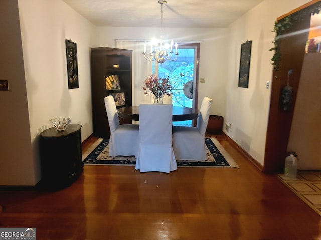 dining area with a chandelier and wood-type flooring