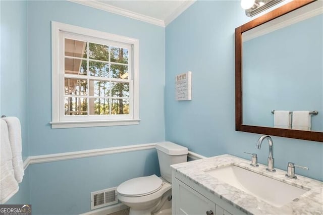 bathroom featuring ornamental molding, vanity, and toilet