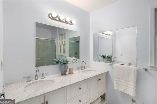 bathroom featuring vanity and an enclosed shower