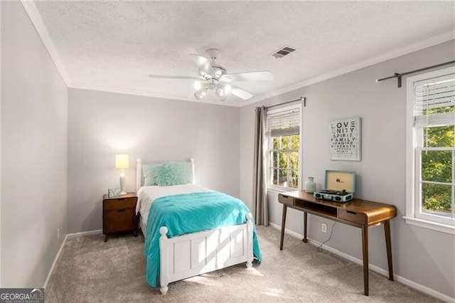 carpeted bedroom featuring a textured ceiling, a barn door, ceiling fan, and crown molding