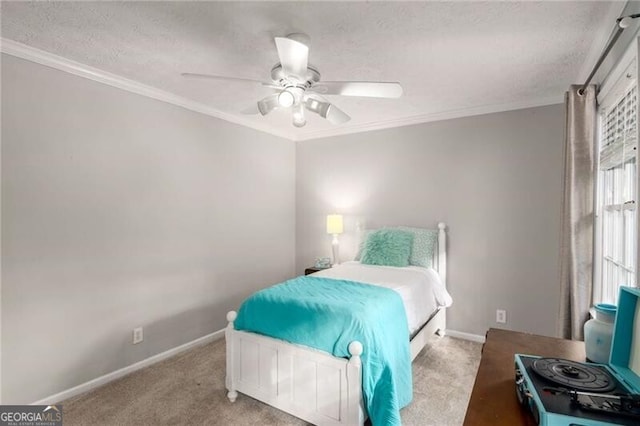 carpeted bedroom with ornamental molding, a textured ceiling, and ceiling fan