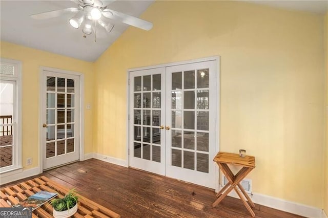 doorway to outside featuring dark wood-type flooring, vaulted ceiling, ceiling fan, and french doors