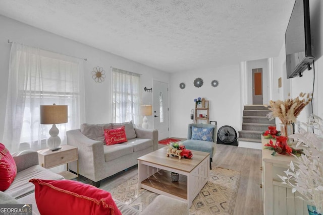 2611 Kings Cir, Lawrenceville, GA 30044 - living area with wood finished floors, stairs, and a textured ceiling