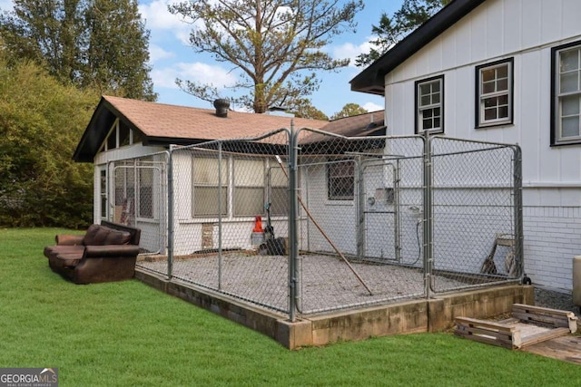 2611 Kings Cir, Lawrenceville, GA 30044 - rear view of property featuring board and batten siding, an outbuilding, and a lawn