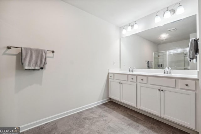 bathroom with a shower with shower door and vanity