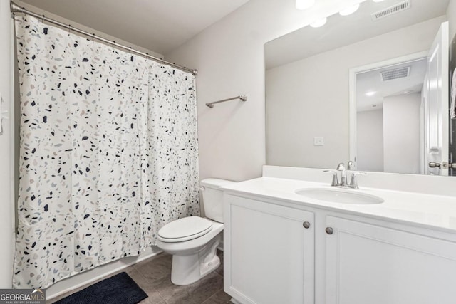 bathroom with vanity, tile patterned floors, toilet, and a shower with curtain