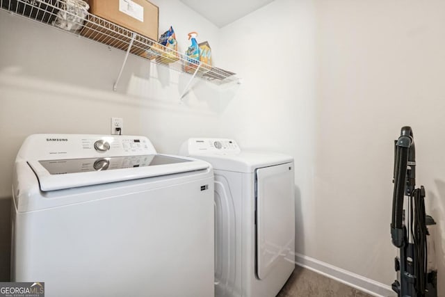 clothes washing area with washing machine and clothes dryer