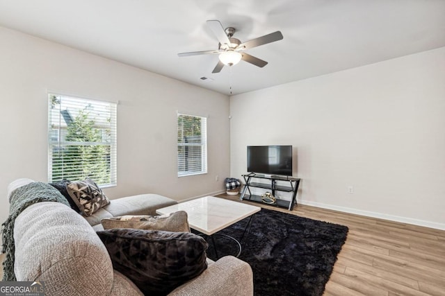 living room with ceiling fan and wood-type flooring