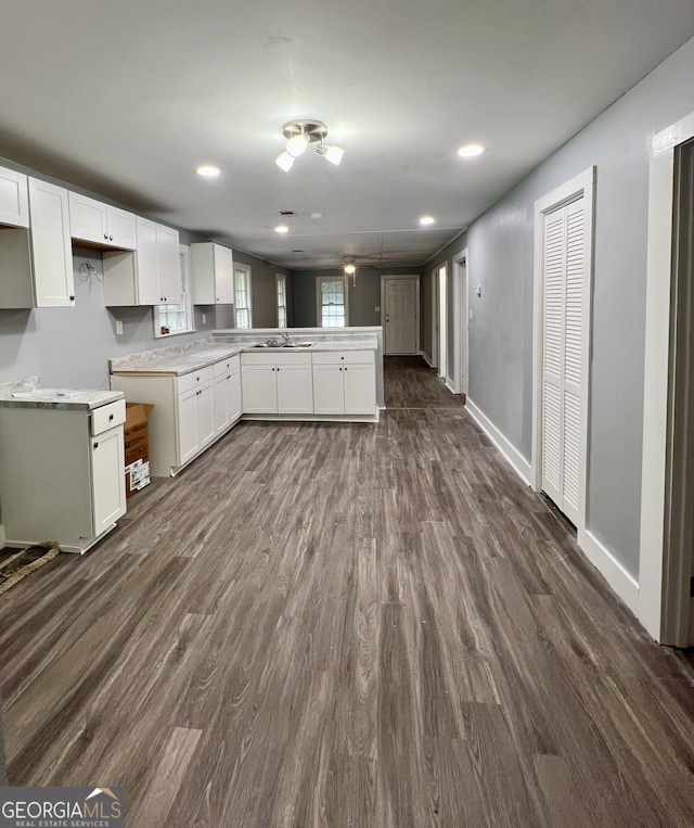 kitchen featuring sink, dark wood-type flooring, and white cabinets