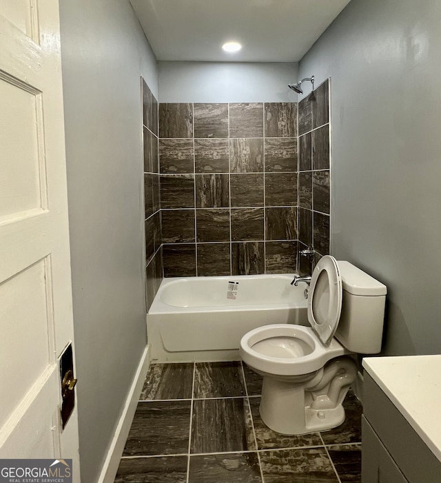 full bathroom with vanity, toilet, and tiled shower / bath combo