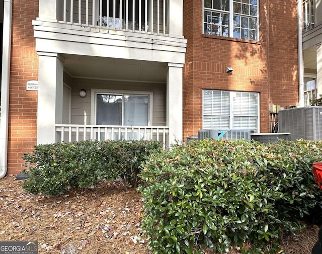 property entrance with central AC unit and a balcony