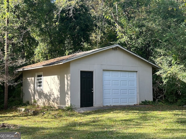 garage featuring a lawn