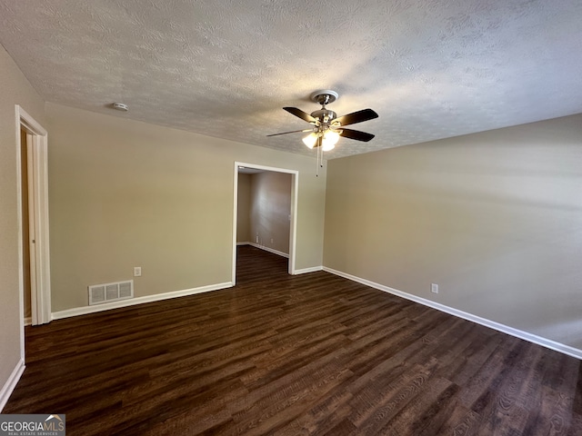 unfurnished room featuring dark wood-type flooring, a textured ceiling, and ceiling fan