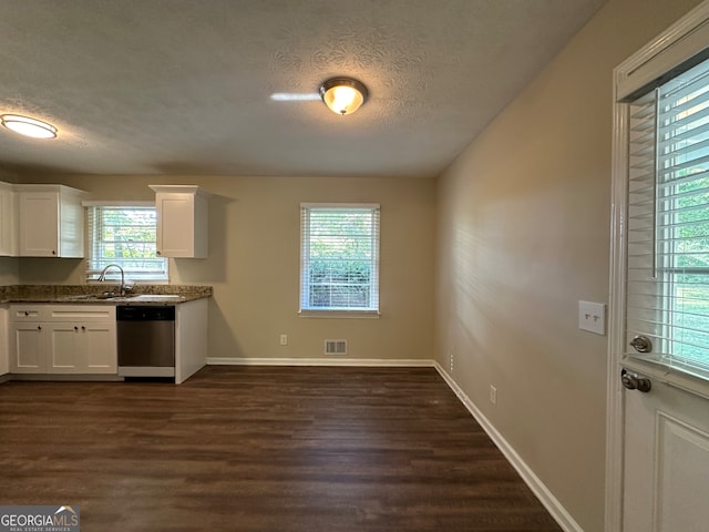 kitchen featuring dark stone countertops, a textured ceiling, white cabinets, dishwasher, and dark hardwood / wood-style flooring