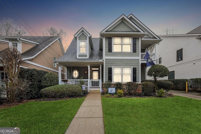 view of front facade featuring a porch and a lawn