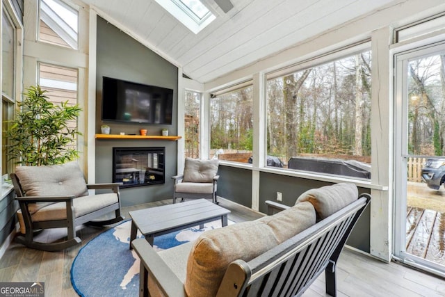 sunroom featuring lofted ceiling with skylight and wooden ceiling