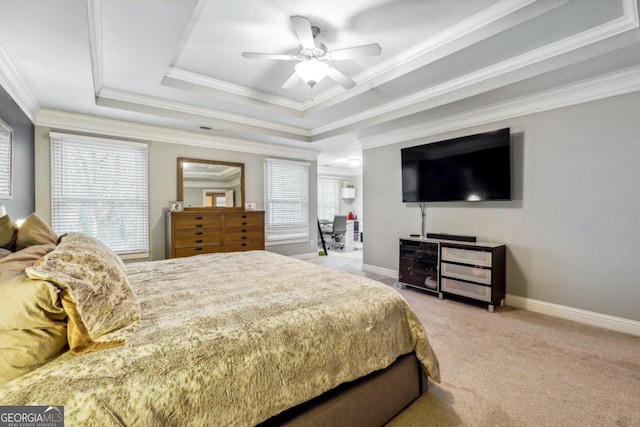 bedroom with a raised ceiling, multiple windows, crown molding, and ceiling fan