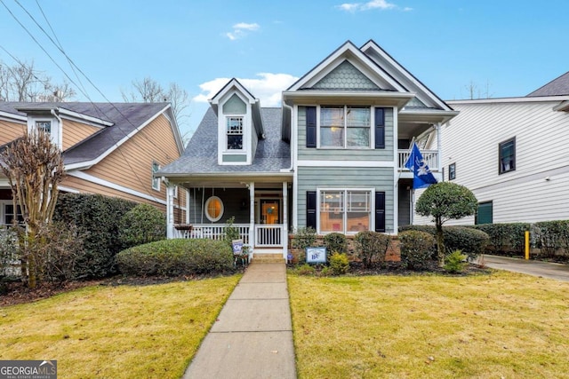 view of front facade featuring a front yard and a porch